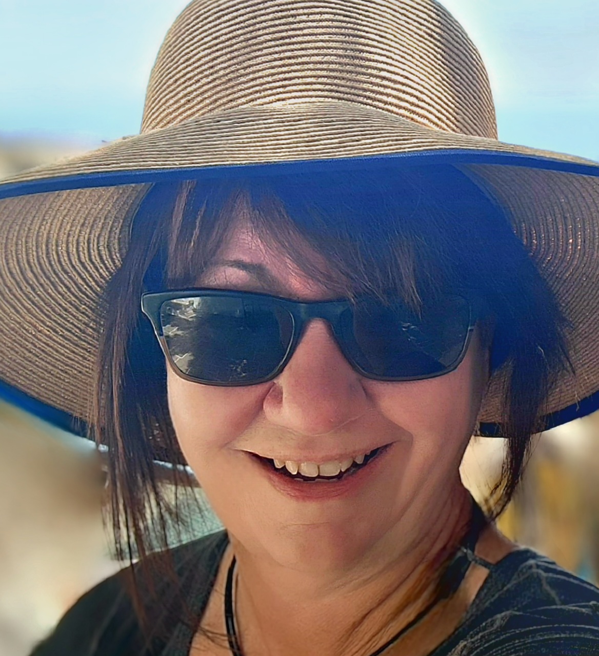 Headshot of Lisa Yoder, white female, in hat and sunglasses