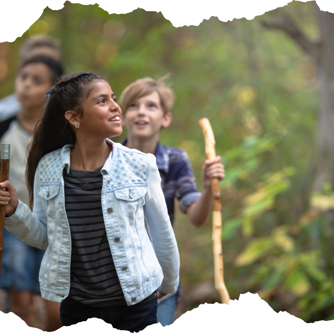 Children hiking with wooding hiking sticks