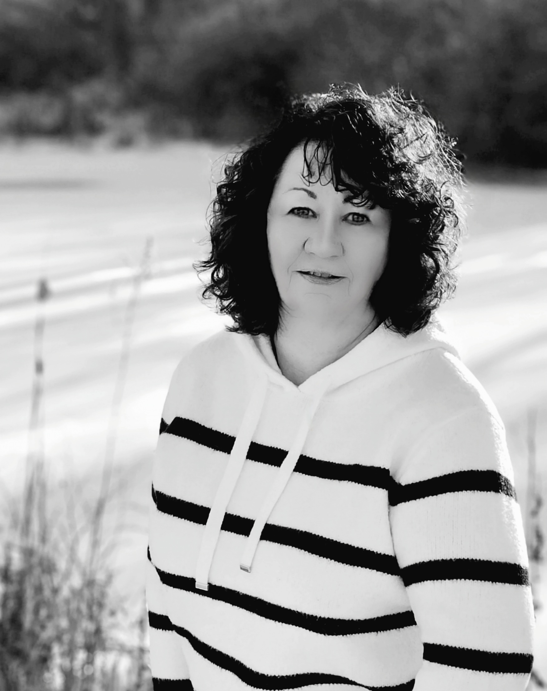 Profile photo of the author in front of a frozen pond, black and white rectangle