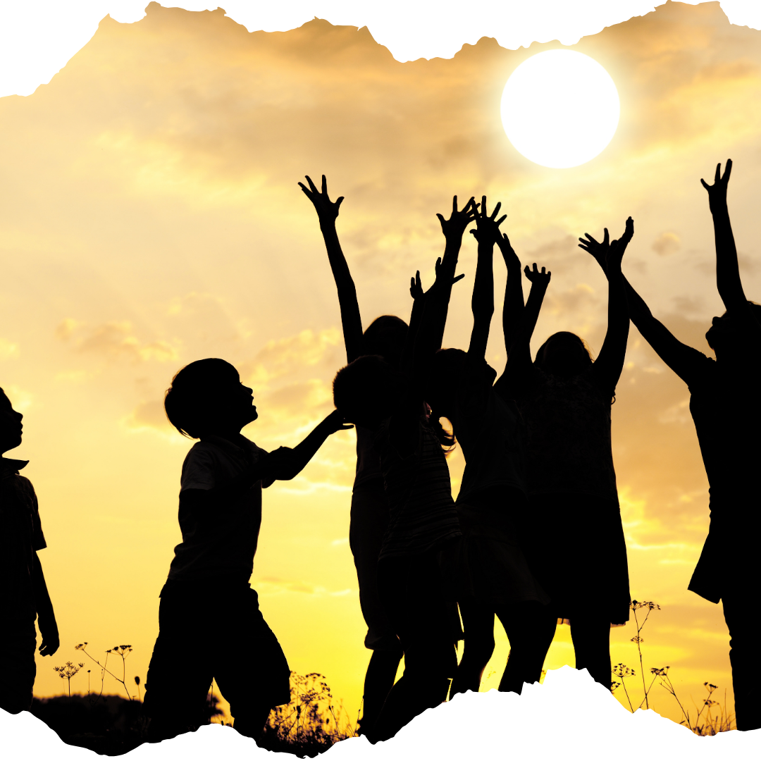 Silhouette of children with sun in the background, arms raised joyfully