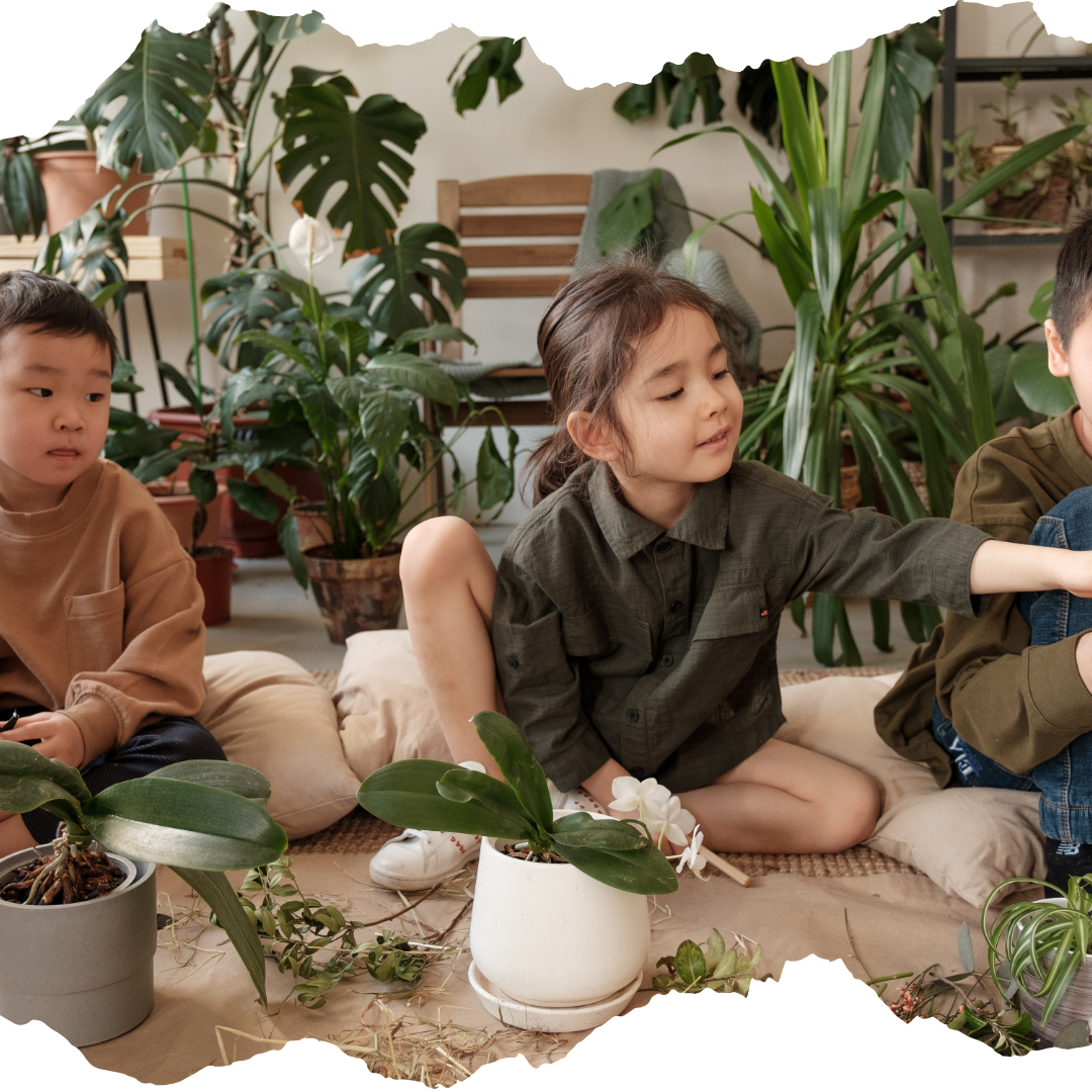 Children sitting on floor with plants