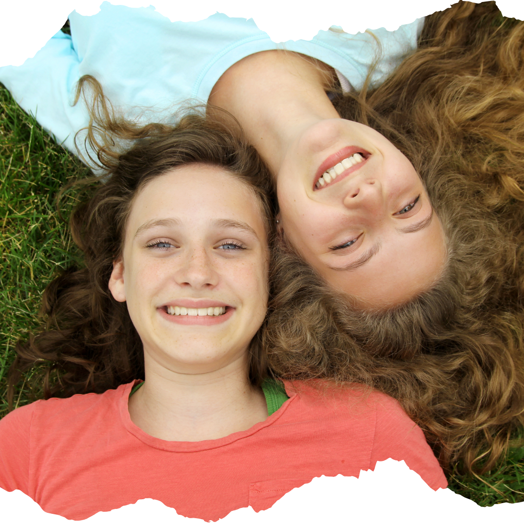 Two teens laying on the ground looking up; cropped around the heads